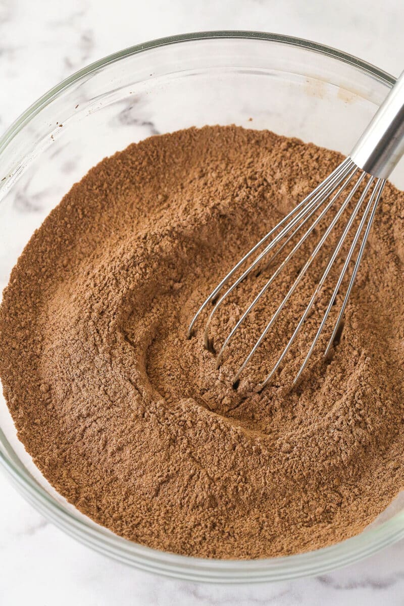 These Chocolate Muffins are so tender and supremely moist. Plus, they're loaded with chocolate flavor and packed with chocolate chips! Combining the dry ingredients for chocolate muffins.