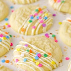 Decorated Coconut Sugar Cookies drying on parchment paper.