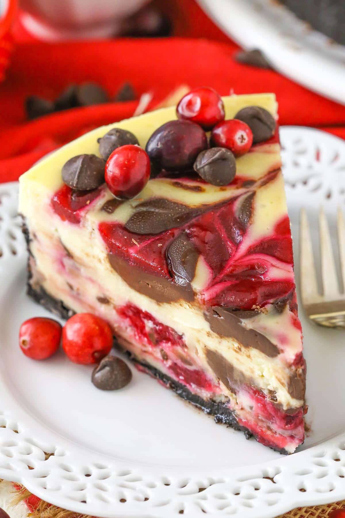 Close up of a slice of cranberry fudge swirl cheesecake.