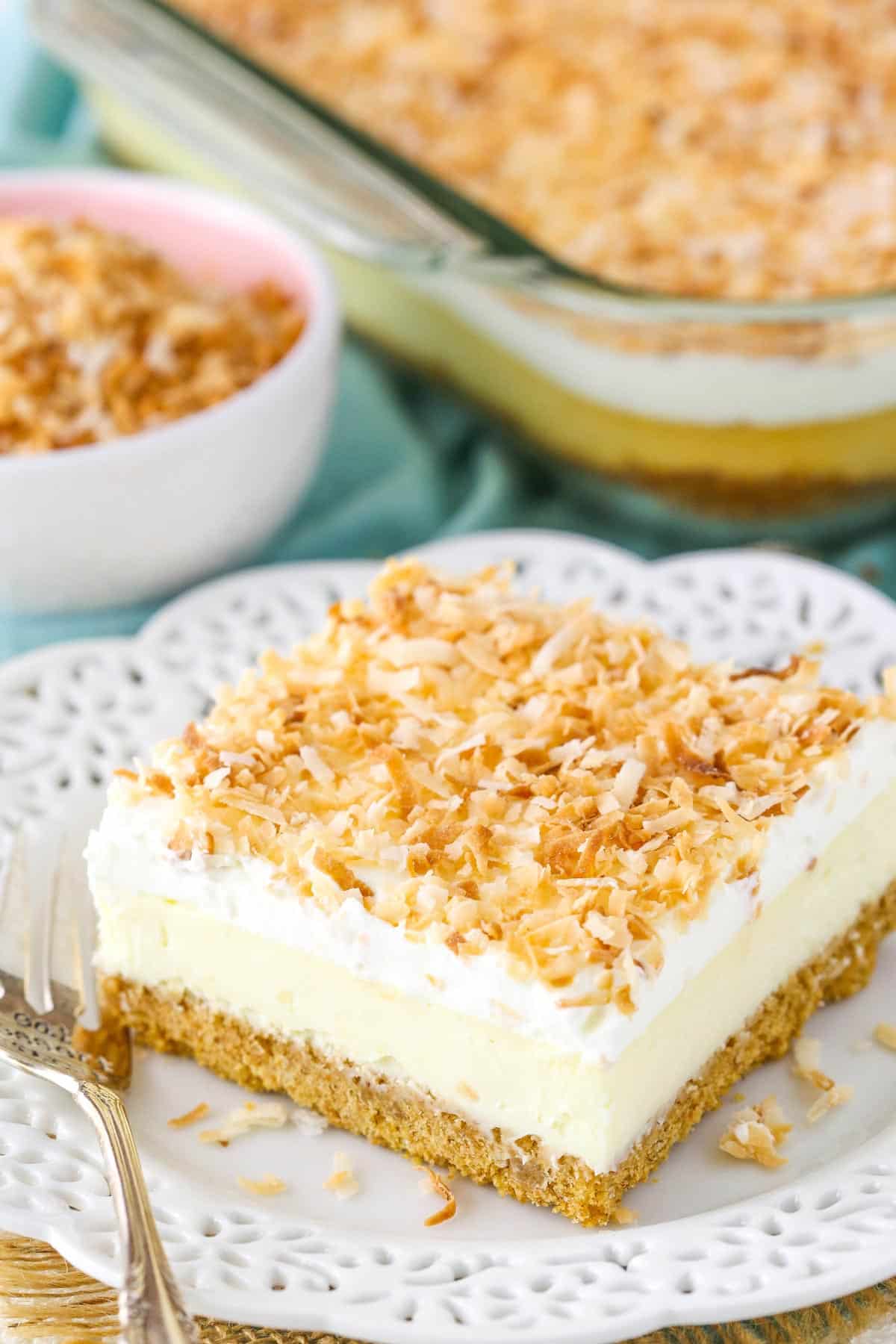A slice of easy coconut cheesecake on a small white plate.