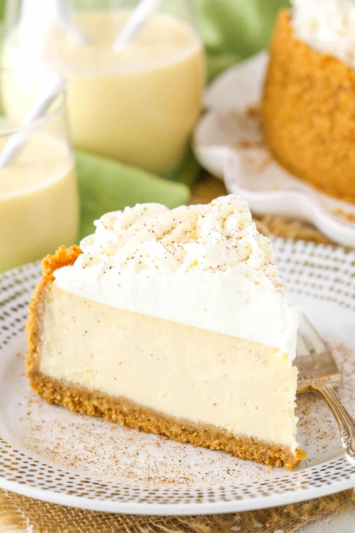 A slice of eggnog cheesecake on a small white and gold plate.