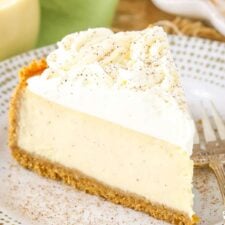 A slice of eggnog cheesecake on a small white plate.