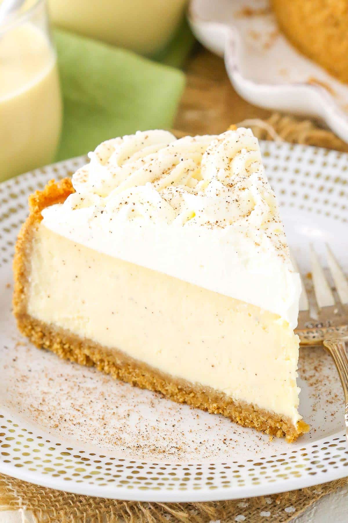 A slice of eggnog cheesecake on a small white plate.
