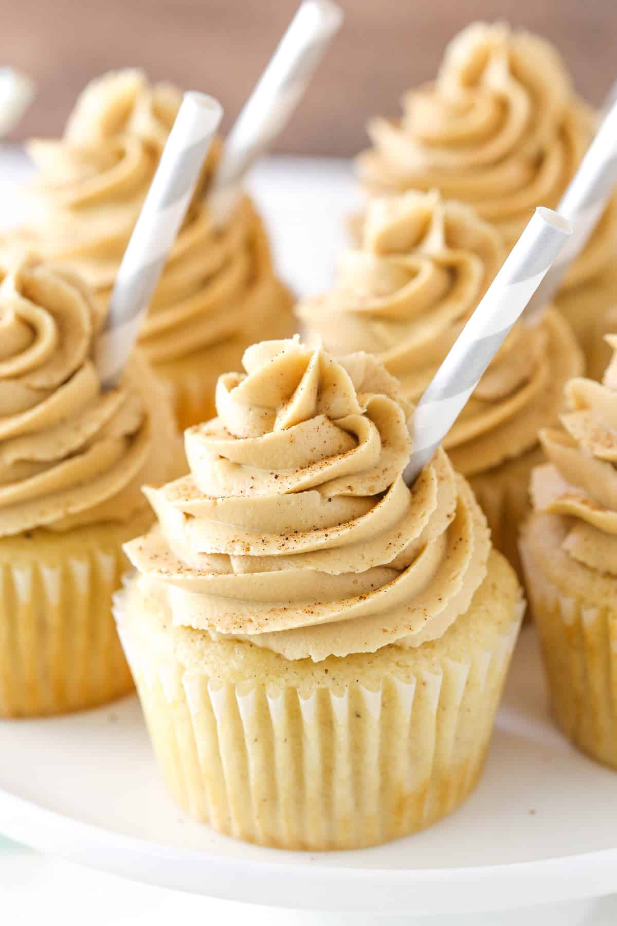 Several eggnog latte cupcakes on a white plate.