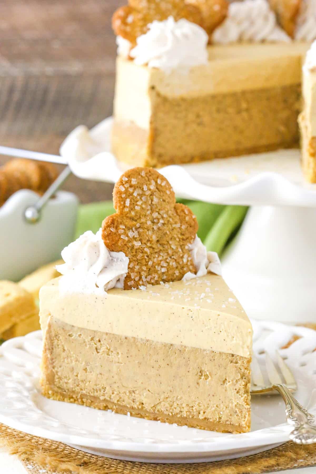 A slice of gingerbread cheesecake on a small white cake plate.