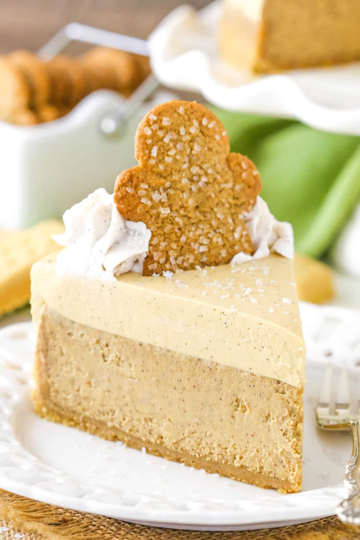 A slice of gingerbread cheesecake on a small white cake plate.