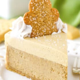 A slice of gingerbread cheesecake on a cake plate.