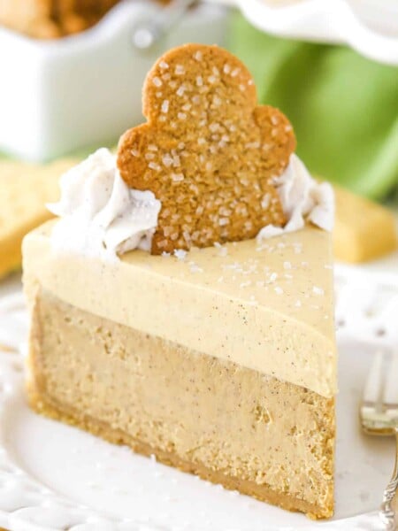 A slice of gingerbread cheesecake on a cake plate.