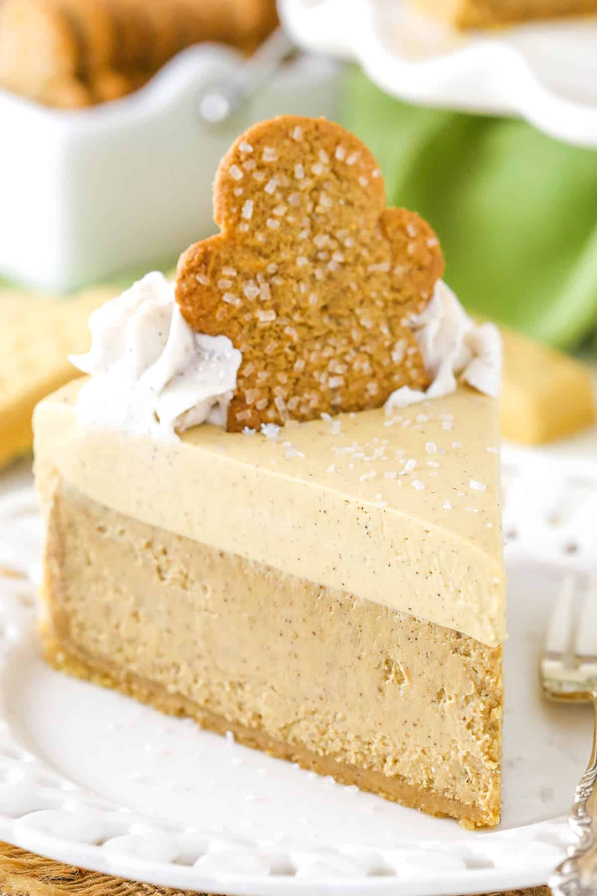 A slice of gingerbread cheesecake on a cake plate.
