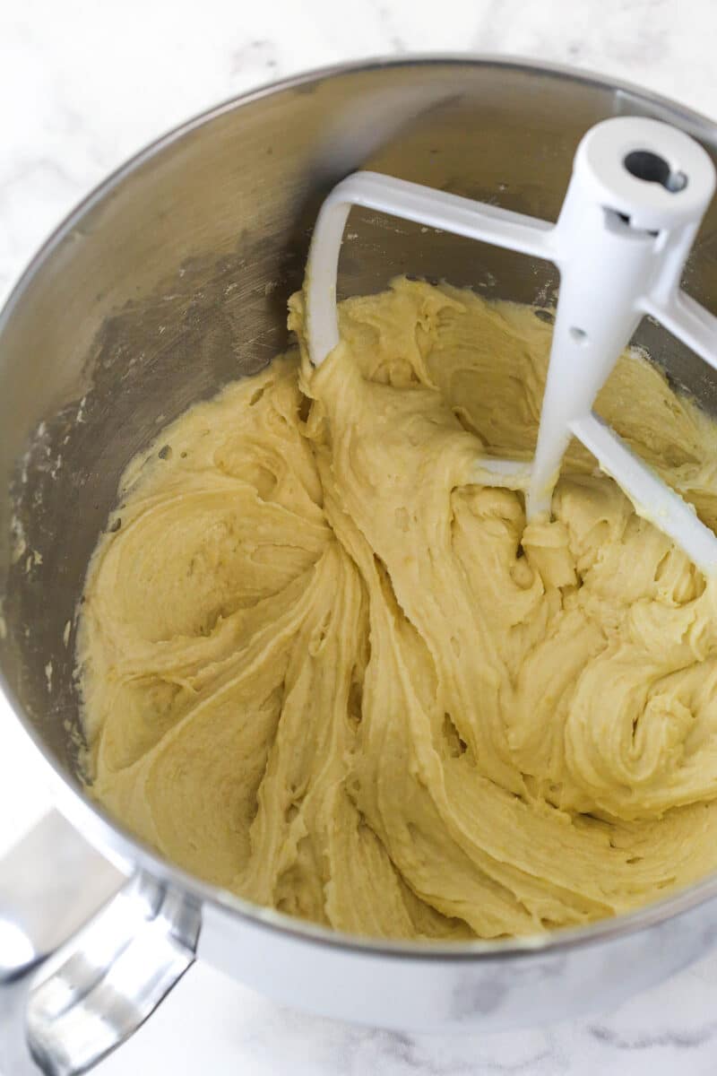 Mixing the dry ingredients into the wet ingredients for lemon blueberry bread.