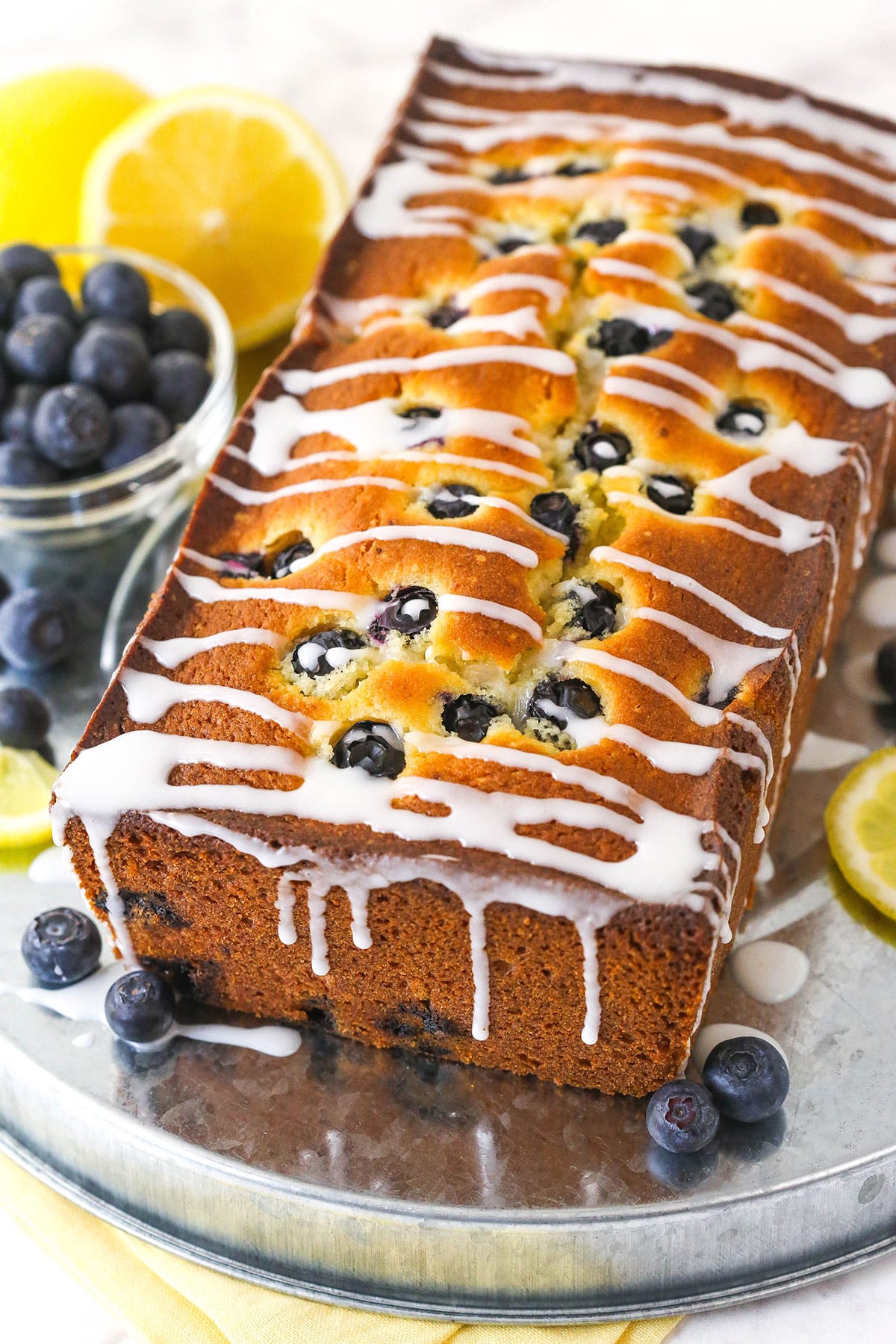 Lemon blueberry bread on a serving plate.