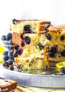 Slices of lemon blueberry bread stacked on top of each other.