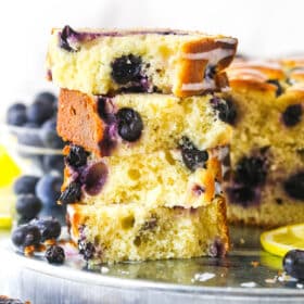 Slices of lemon blueberry bread stacked on top of each other.