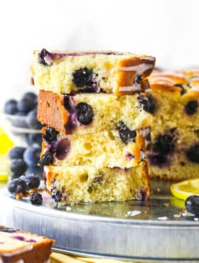 Slices of lemon blueberry bread stacked on top of each other.