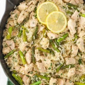 Top view of a skillet of lemon rosemary chicken and rice.
