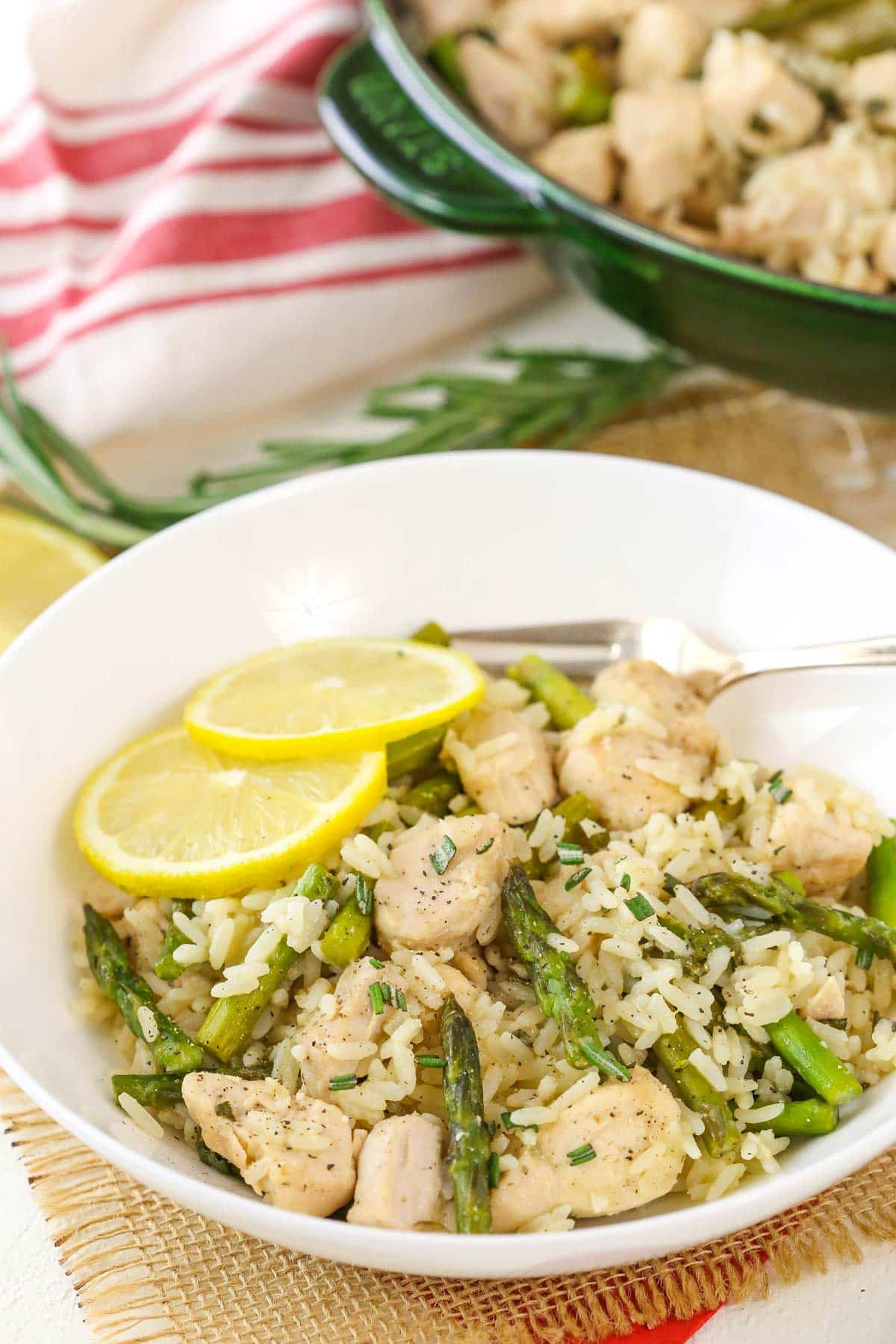 Side view of a bowl of lemon rosemary chicken and rice.
