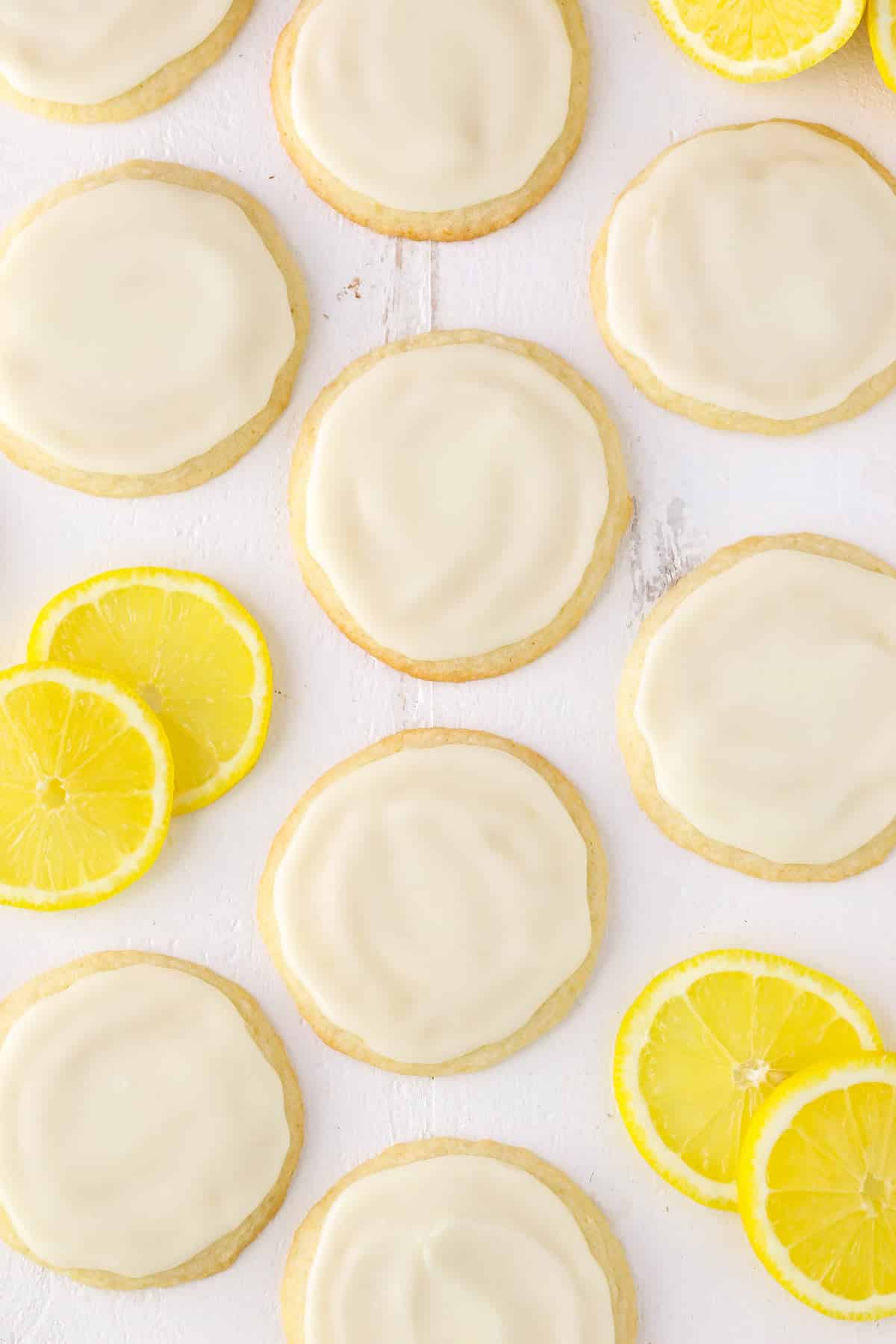Top view of Limoncello Cookies and lemon slices on a white surface.