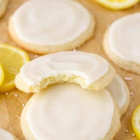 Close up of a stack of three Limoncello Cookies with a bite taken out of the top cookie.