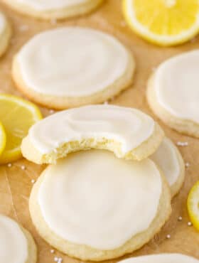 Close up of a stack of three Limoncello Cookies with a bite taken out of the top cookie.