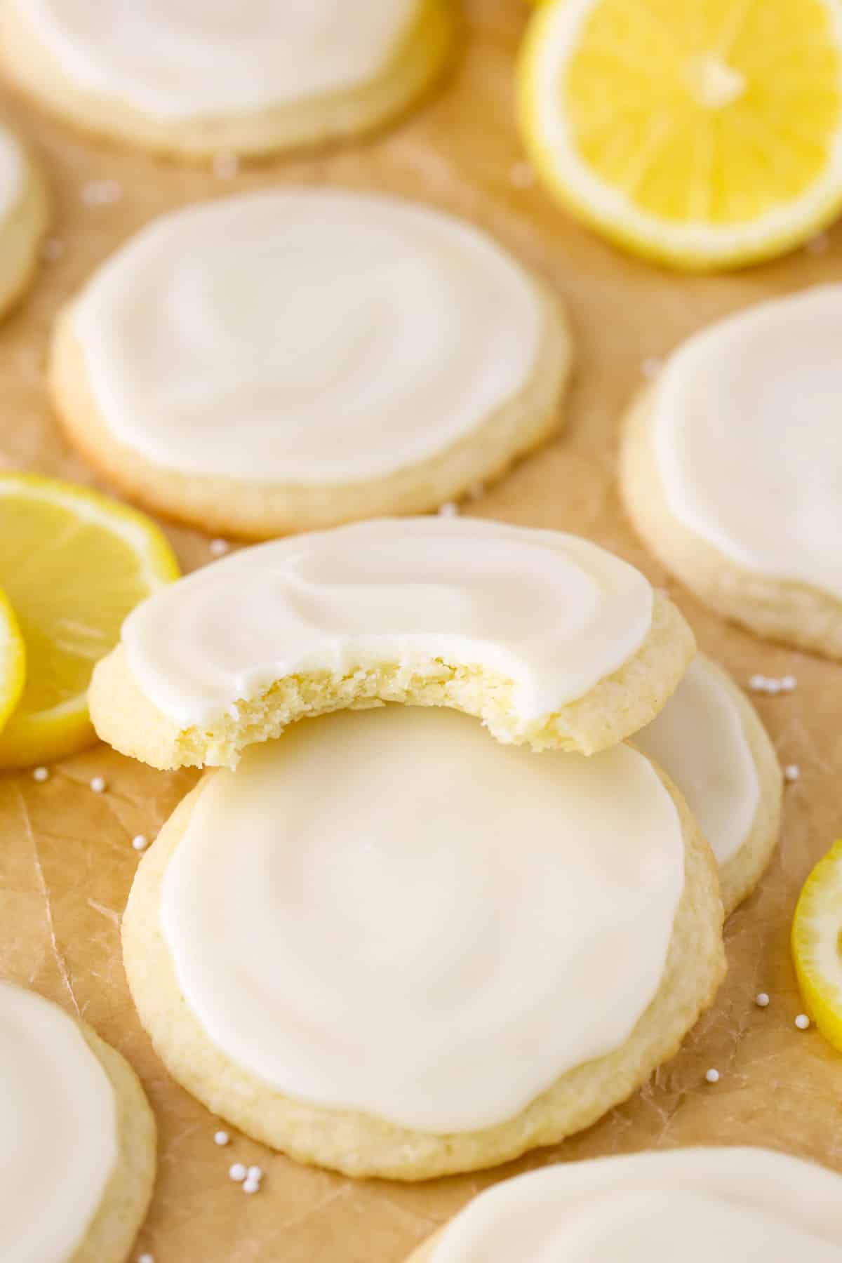 Close up of a stack of three Limoncello Cookies with a bite taken out of the top cookie.