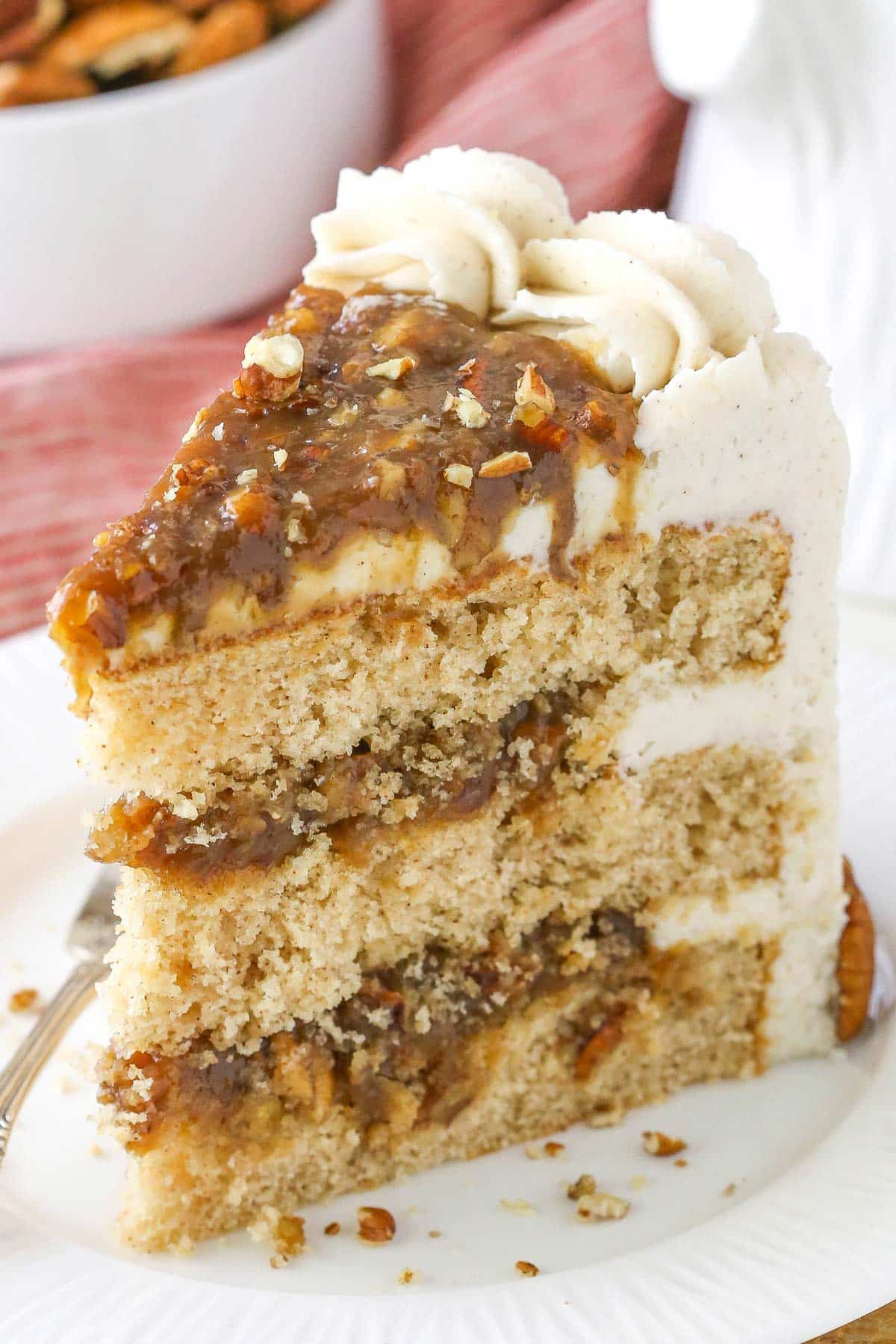 A slice of pecan pie layer cake on a small white plate.