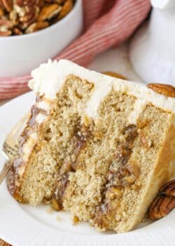 A slice of pecan pie layer cake on a white plate.