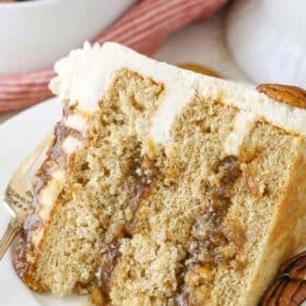 A slice of pecan pie layer cake on a white plate.