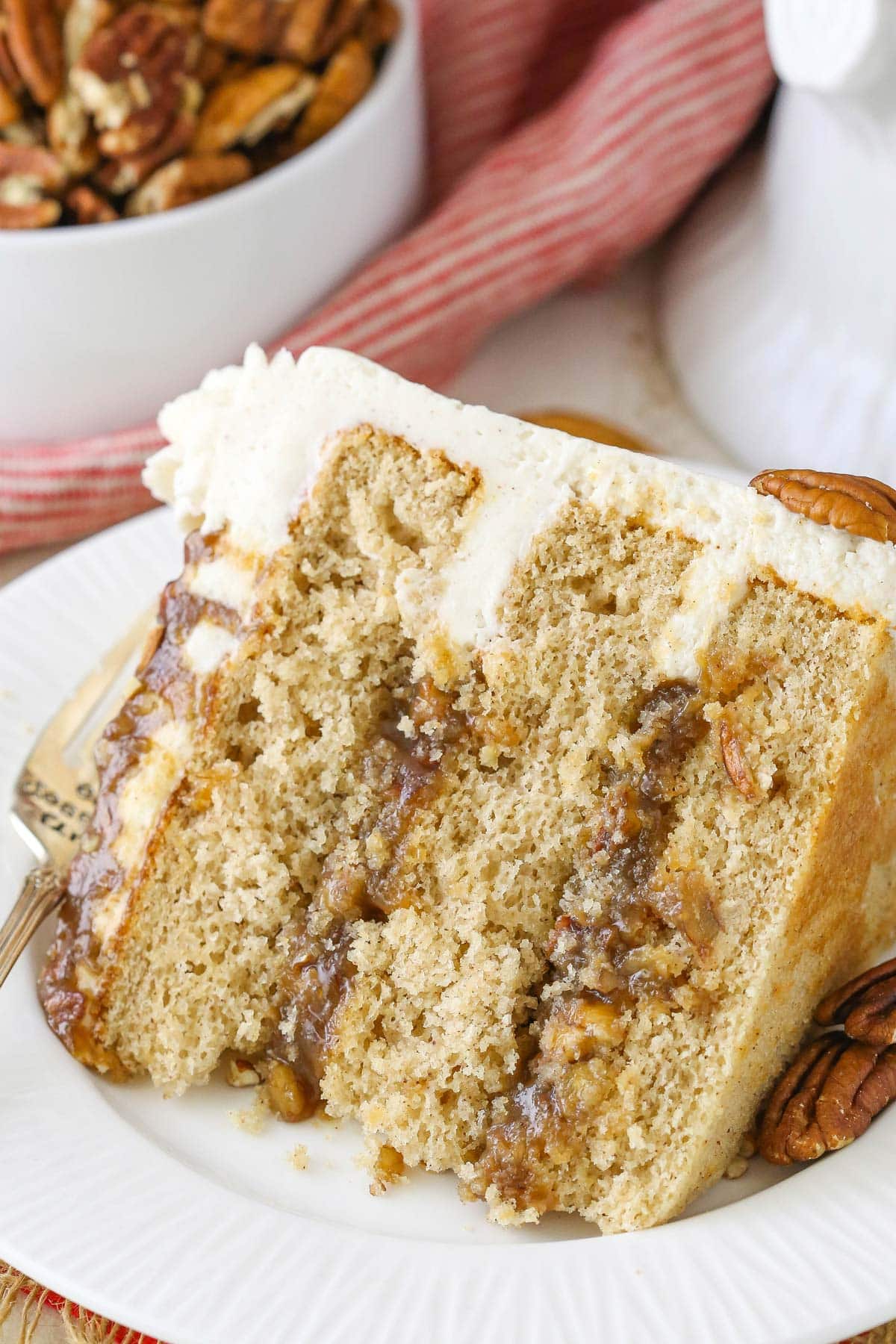 A slice of pecan pie layer cake on a white plate.