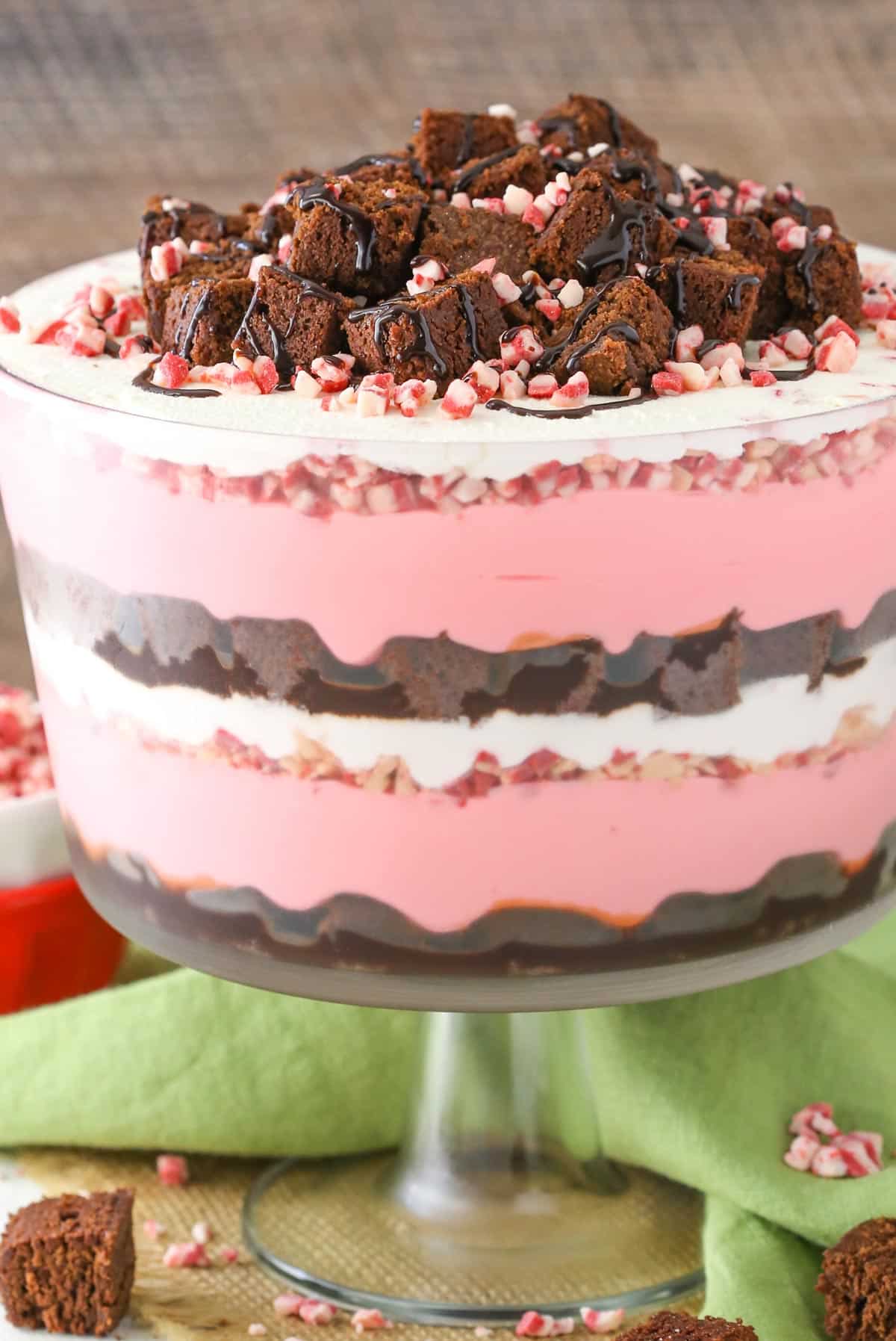 A peppermint cheesecake brownie trifle in a clear trifle bowl.