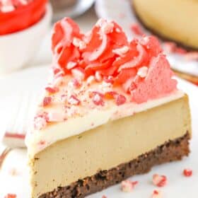 A slice of peppermint espresso brownie cheesecake on a white plate.