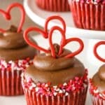Close up of a red velvet cupcake with chocolate cream cheese frosting.