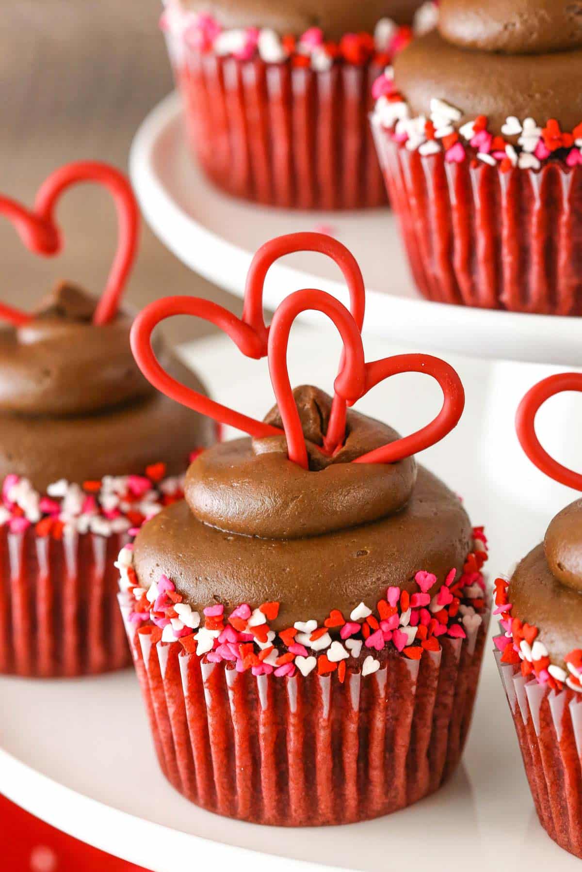 Close up of a red velvet cupcake with chocolate cream cheese frosting.