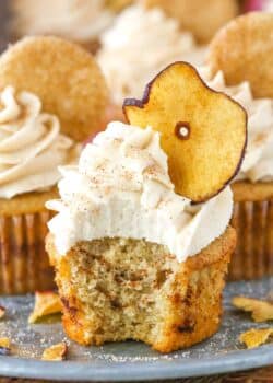 An apple snickerdoodle cupcake with a bite taken out of it.
