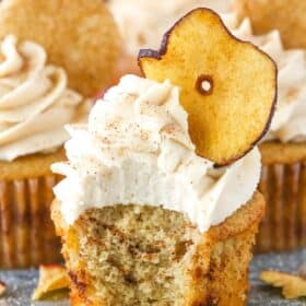 An apple snickerdoodle cupcake with a bite taken out of it.