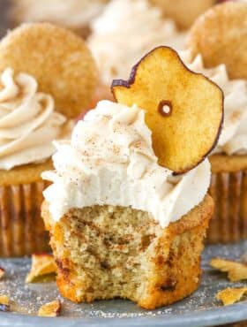 An apple snickerdoodle cupcake with a bite taken out of it.