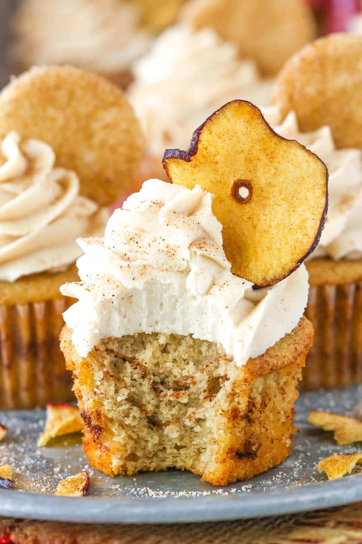 An apple snickerdoodle cupcake with a bite taken out of it.