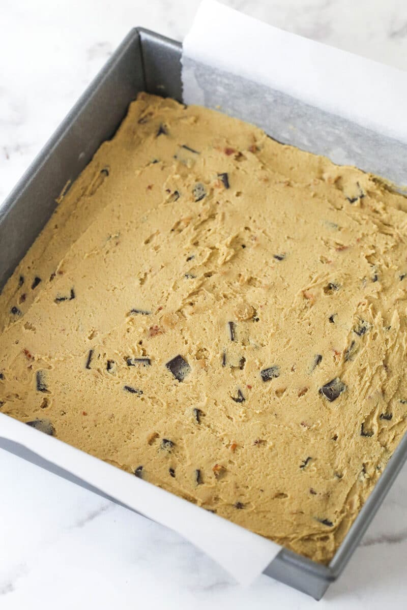 cookie dough spread evenly in baking pan