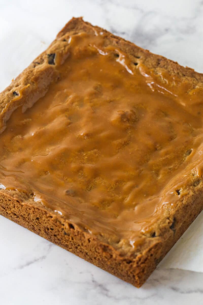 cookie bars with a layer of caramel spread on top