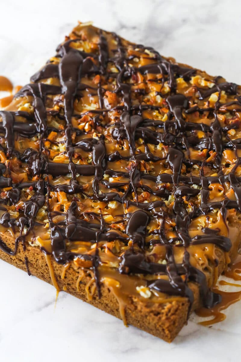cookie bars with caramel and chocolate drizzles added on top