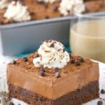 A slice of baileys chocolate mousse brownie cake on a small white plate.