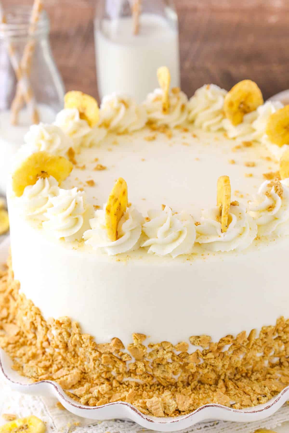 A banana cream layer cake on a cake plate.