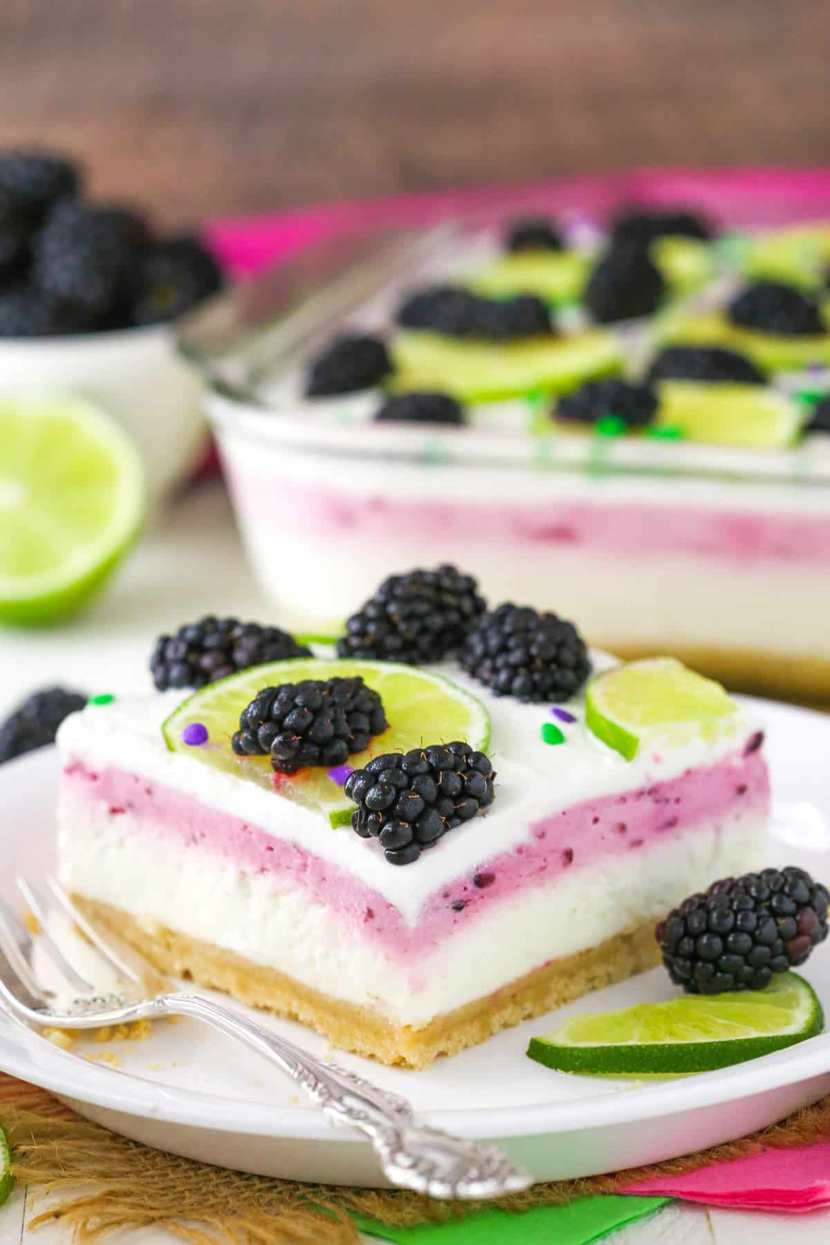 A slice of blackberry lime lush on a small plate.