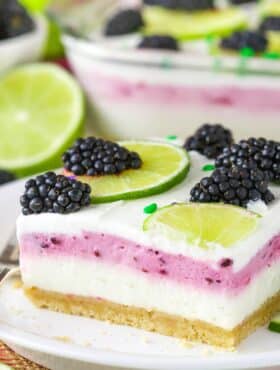 Close up of a slice of blackberry lime lush.