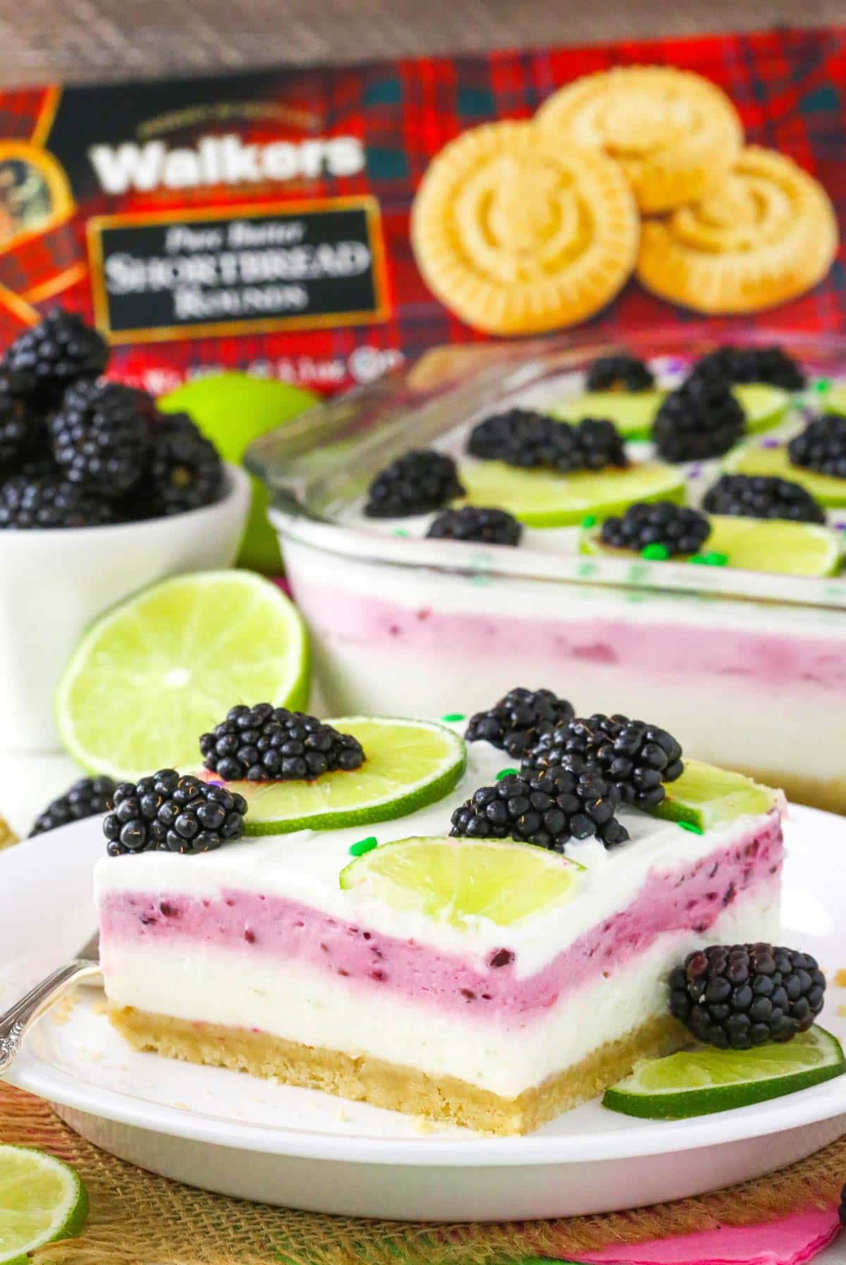 A slice of blackberry lime lush on a small white plate.
