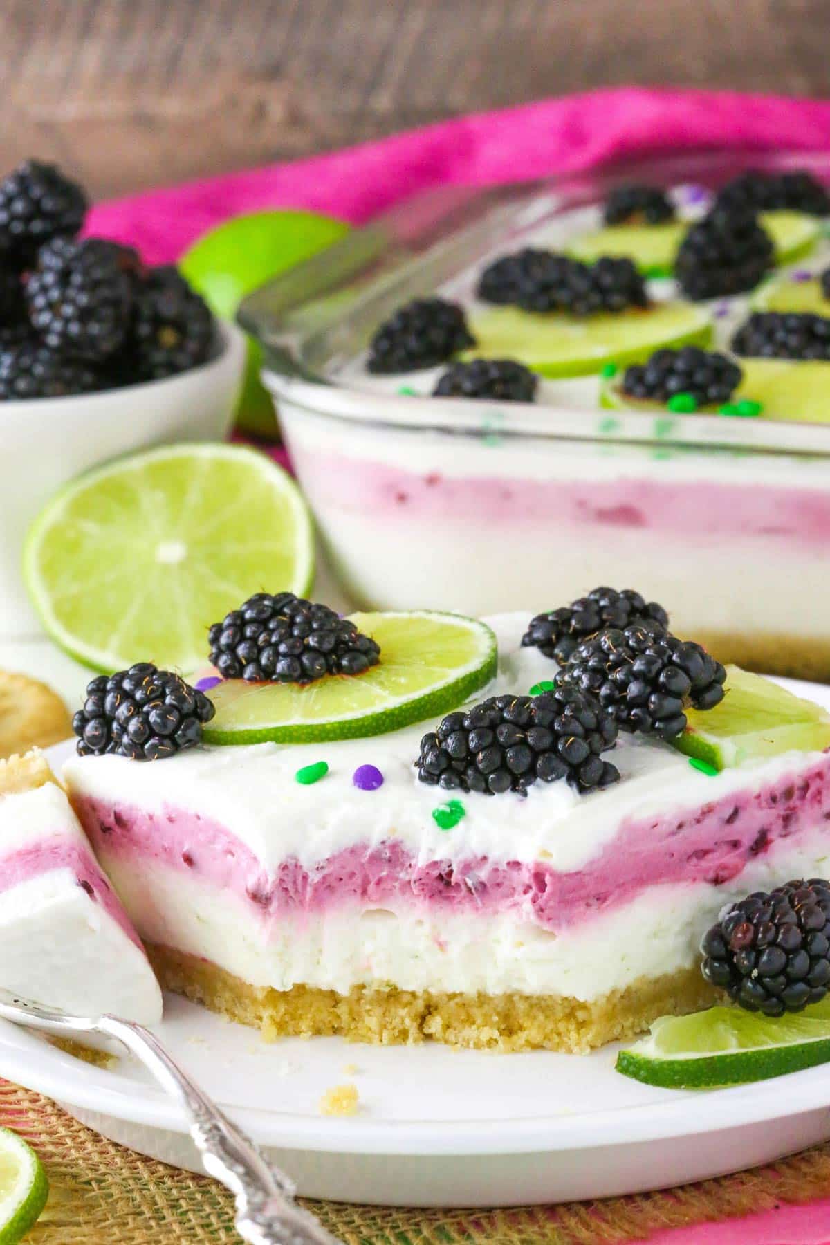 A slice of blackberry lime lush with a few bites missing.
