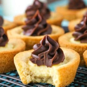 A boston cream pie cookie cup with a bite taken out of it.