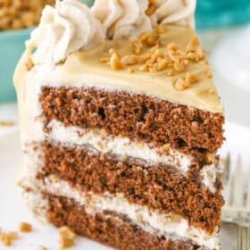 A slice of bourbon spice toffee layer cake on a white plate.