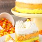 A slice of candy corn icebox cake with a bite removed.