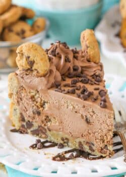 A slice chocolate chip cookie crust cheesecake on a white plate.