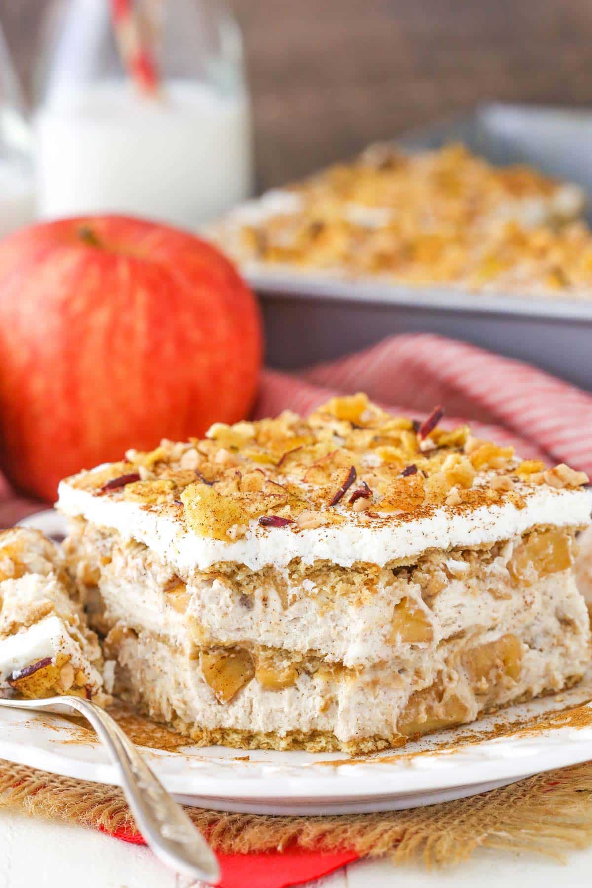 A slice of cinnamon apple icebox cake with a bite removed.